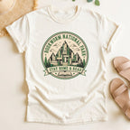Ivory t-shirt with green 'Bookworm National Park' graphic on a light surface.