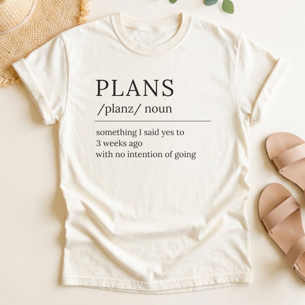 Ivory t-shirt with humorous 'PLANS' definition text on a light background