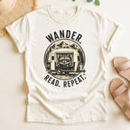 Ivory t-shirt with 'Wander. Read. Repeat.' graphic design on a light background