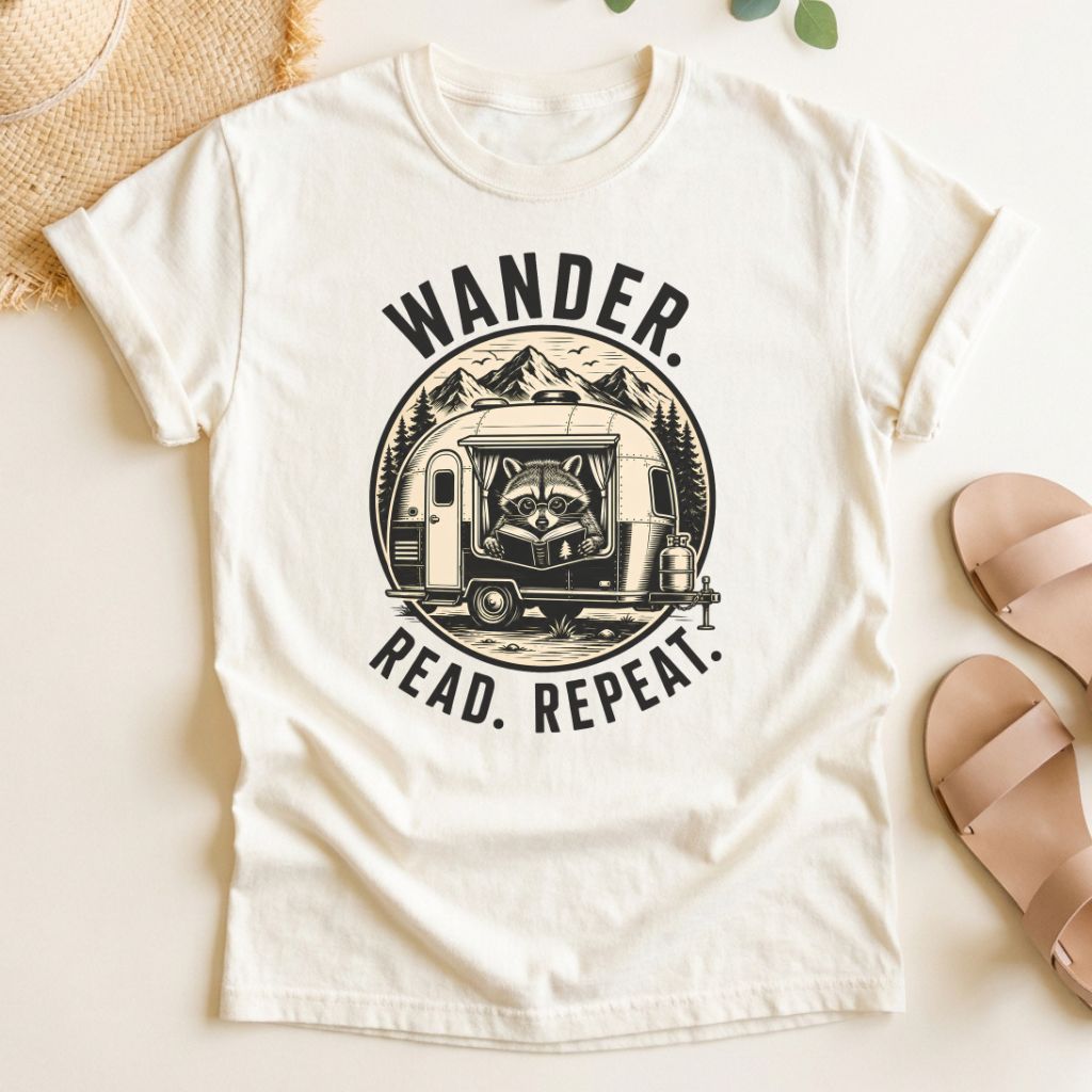 Ivory t-shirt with 'Wander. Read. Repeat.' graphic design on a light background
